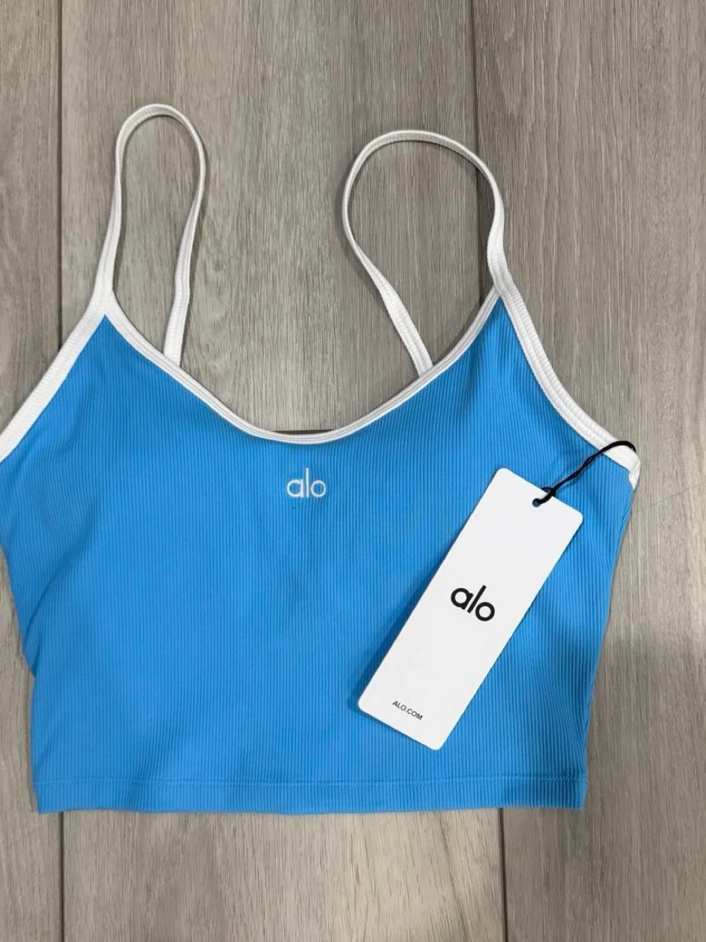 ALO Yoga Goddess Ribbed First Pick Bra Tank in Azure Blue with White Trim.